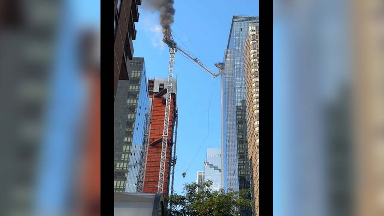 New York City construction crane bursts into flames before collapse